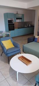 a living room with a couch and a table at NANA-Grand Appartement Cosy-A33-2 Chambres Climatisées- cuisine équipée- Terrasse in Cayenne