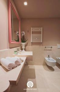 a bathroom with a sink and a toilet and a tub at Officina del Sole in Montegiorgio