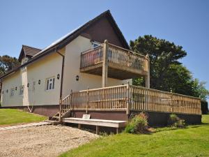 a house with a large deck on the side of it at 4 Bed in Barnstaple ELLER in Fremington