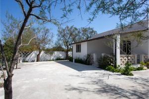 a white house with a large driveway at Villa Sabbia Magica 100 meters from sea - Happy Rentals in Porto Cesareo +19 photos