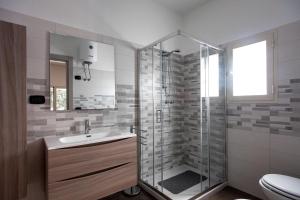 a bathroom with a shower and a sink and a toilet at Villa Sabbia Magica 100 meters from sea - Happy Rentals in Porto Cesareo