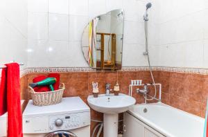 a bathroom with a sink and a tub and a mirror at YourHouse 3-х комнатная квартира с видом на горы in Almaty