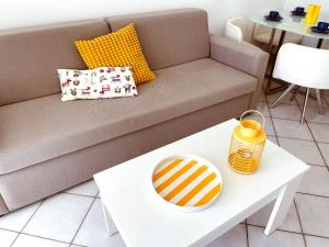 a living room with a couch and a table at Bungalow Monte Golf in Playa del Ingles