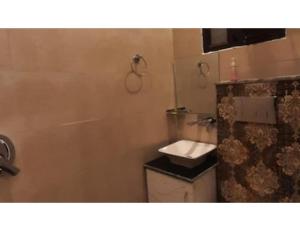 a small bathroom with a sink and a toilet at Hotel Park Blu, panipat in Pānīpat