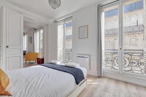 เตียงในห้องที่ Joli appartement Champs Elysées - 6P