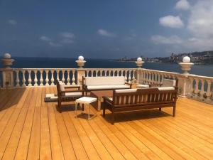 a wooden deck with benches and a view of the ocean at Portaluna Hotel & Resort in Jounieh