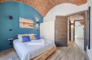 a bedroom with a large bed with blue walls at Superbe Appartement Au Coeur du Vieux Nice ! in Nice