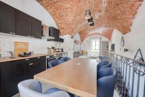 a kitchen with a wooden table and blue chairs at Superbe Appartement Au Coeur du Vieux Nice ! in Nice