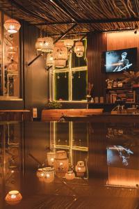 a room with a television and a table with lights at The Living Roof in Shillong