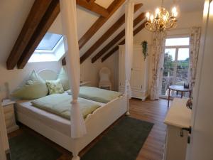 a bedroom with a bed and a chandelier at Der Moserhof in Oberaurach