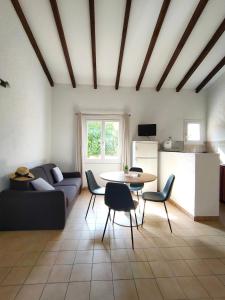 a living room with a couch and a table at Résidence Les Cigales in Porto-Vecchio