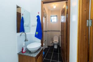 a small bathroom with a toilet and a sink at Mombasa Comfy Stay Bamburi 1br in Mombasa