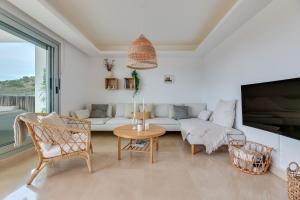 a living room with a couch and a table and chairs at Avalon in Benahavís