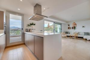 a kitchen and living room with a large window at Avalon in Benahavís