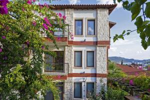 a house with a balcony on the side of it at Luna Kaş in Kaş