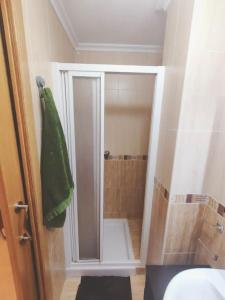 a bathroom with a shower with a glass door at Extraordinario ático de 80 m2 en urbaniz privada in Noja