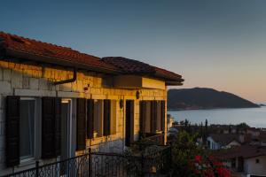 a yellow house with windows and a view of the ocean at Luna Kaş in Kaş