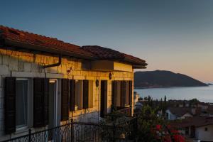 a house with a balcony with a view of the ocean at Luna Kaş in Kaş