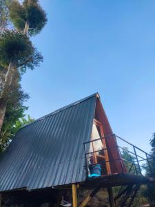 a tree house with a metal roof at Papathi farm house in Kodaikānāl