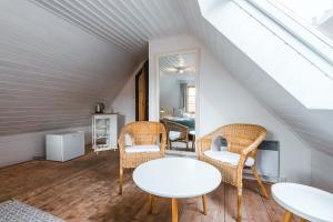 a room with a white table and chairs in a attic at Penzion U náměstí - At the Town Square in Český Krumlov