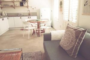a living room with a couch and a table at Stylish family unit in Walmer in Gqeberha