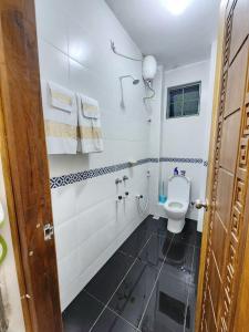 a bathroom with a toilet and a sink at Mombasa Comfy Stay Bamburi 1br in Mombasa