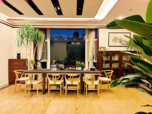 a dining room with a table and chairs at Zen of Tiger Luxury garden villa with sea view大理老虎的觉后禅独栋海景花园别墅 in Dali