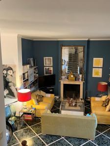 een woonkamer met gele banken en een spiegel bij artemare in Viareggio