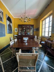 a dining room with a wooden table and chairs at artemare in Viareggio