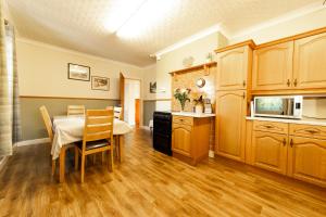 a kitchen with a table and a dining room at An Caladh in Balallan