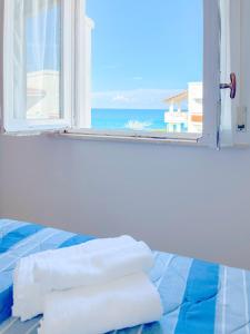 Ένα ή περισσότερα κρεβάτια σε δωμάτιο στο Villetta Tutto Mare Fiumefreddo Bruzio