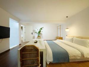 a bedroom with a large bed and a television at Zen of Tiger Luxury garden villa with sea view大理老虎的觉后禅独栋海景花园别墅 in Dali