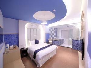 Voodi või voodid majutusasutuse Garden Spring Hotel toas