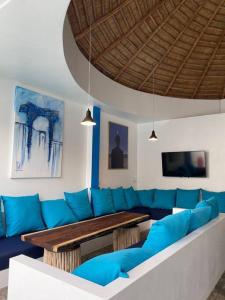 a living room with a blue couch and a table at Magritte - Balinese Style Cosy Villa in Amphoe Koksamui