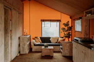 a living room with a couch and a table at Camping Saint-Lambert - Maeva in Millau