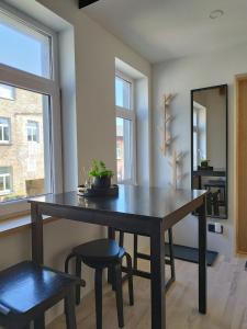 a dining room with a table and two chairs at Courtyard Condo Sunset in Liepāja