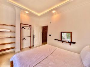 a bedroom with a large bed and a mirror at Zen house in Kas