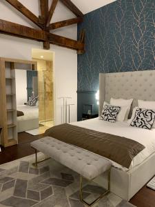 a bedroom with a large bed with a bench in it at La Cabane D'Ambroise in Bordeaux
