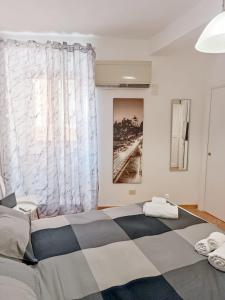 מיטה או מיטות בחדר ב-appartamento teatro marcello