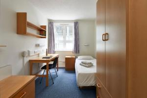 a small room with a bed and a desk at Schafer House London in London