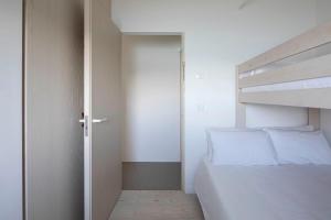 A bed or beds in a room at A Factoria Beach House by Prishomes