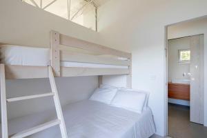 A bed or beds in a room at A Factoria Beach House by Prishomes