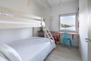 A bed or beds in a room at A Factoria Beach House by Prishomes