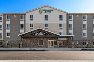 a large hotel with a sign on the front of it at WoodSpring Suites Yorktown Newport News in Newport News