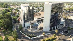 an aerial view of a city with two tall buildings at Hilton Mendoza in Mendoza