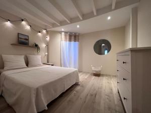 1 dormitorio con 1 cama, vestidor y ventana en La Suite au Village - 4/6 p - 90m2- 3 niveaux, en Gruissan
