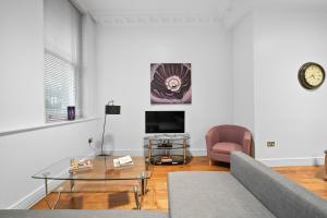 a living room with a couch and a table at Apartment 1, 48 Bishopsgate by City Living London in London