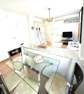 a glass table and chairs in a living room at Уютная квартира рядом с морем in Kemer