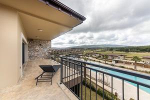 a balcony with a view of a pool at Luxury Villa w Pool Balcony in Regnum Golf Club in Çamlık