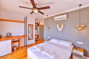 a bedroom with a bed and a ceiling fan at Luna Kaş in Kaş